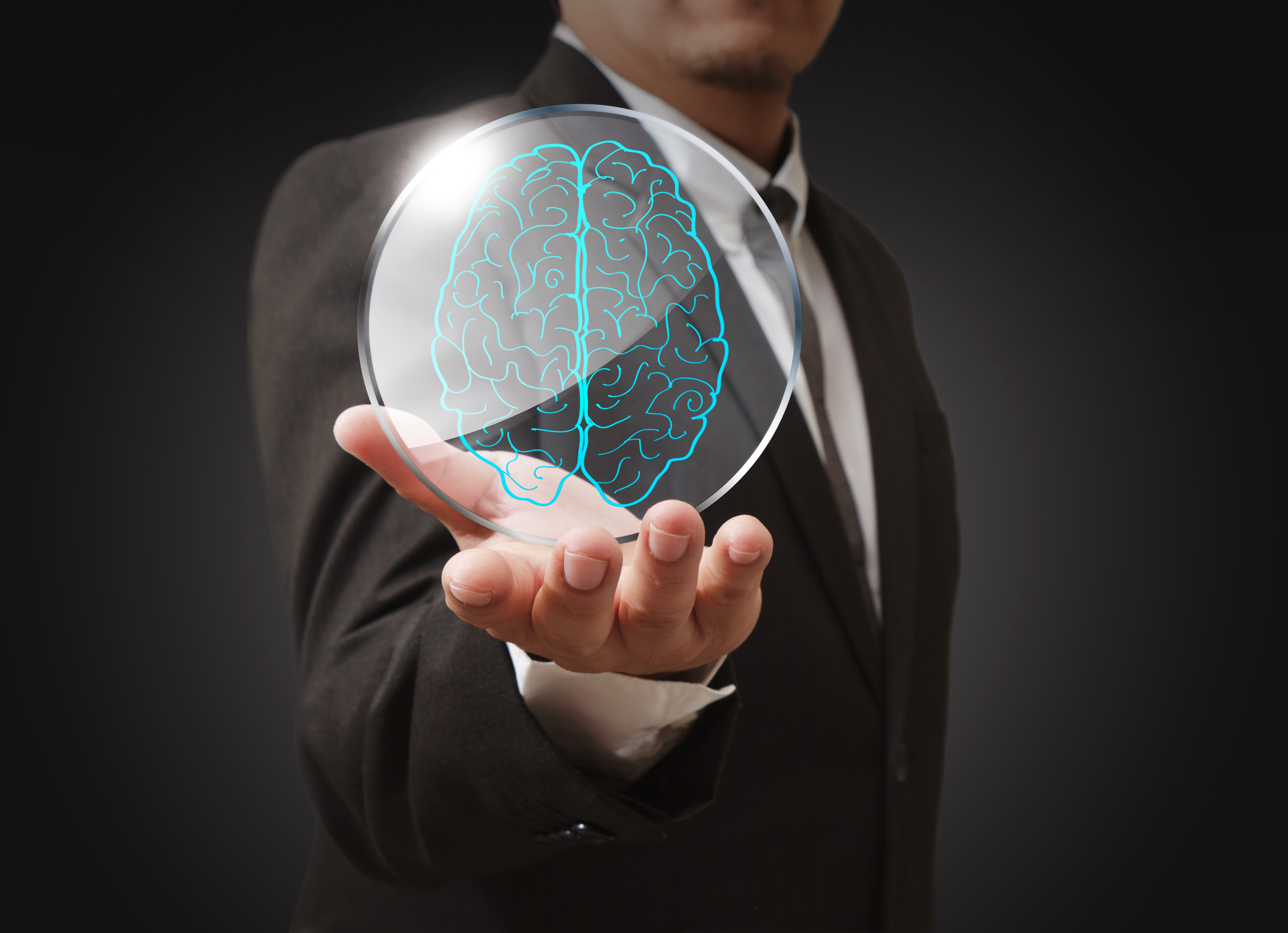 businessman shows a brain in shield glass as concept SBI 300015672 creșterea inteligenței