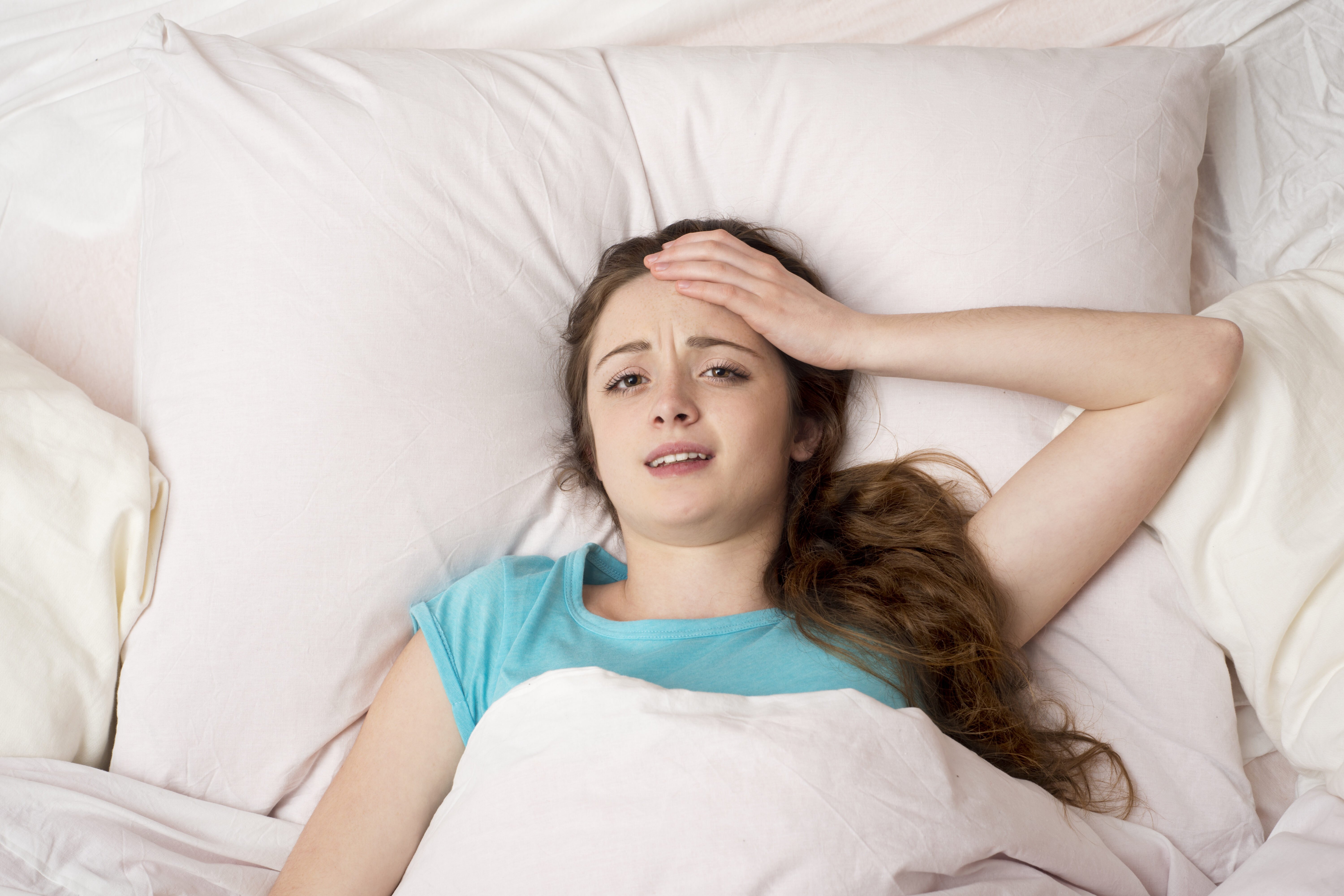sick woman with headache is lying in bed SBI 305124649